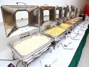 A buffet setup with multiple serving stations, each with a metal container and a spoon. - Metro Resort Pratunam (Bangkok)