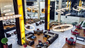 A spacious lobby with multiple seating areas, large circular light fixtures, and a modern architectural design. - Crowne Plaza Riyadh RDC Hotel & Convention by IHG (Riyadh)
