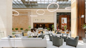 A spacious lobby with a large sectional sofa, multiple armchairs, and a reception desk. - Crowne Plaza Riyadh RDC Hotel & Convention by IHG (Riyadh)