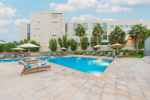 Outdoor pool, open 7:00 AM to 10:00 PM, pool loungers