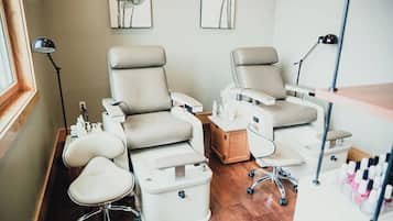 Relax in comfort with two spacious chairs, each featuring a footrest and personal table.