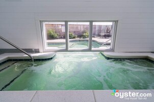 Una piscina techada, una piscina al aire libre de temporada, sombrillas