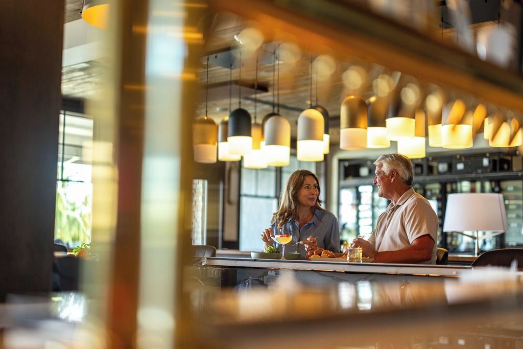 A bar area with hanging pendant lights and a bar counter.