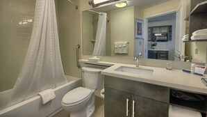 A modern bathroom with a bathtub, toilet, and sink. - Candlewood Suites Columbus - Grove City by IHG (Grove City)