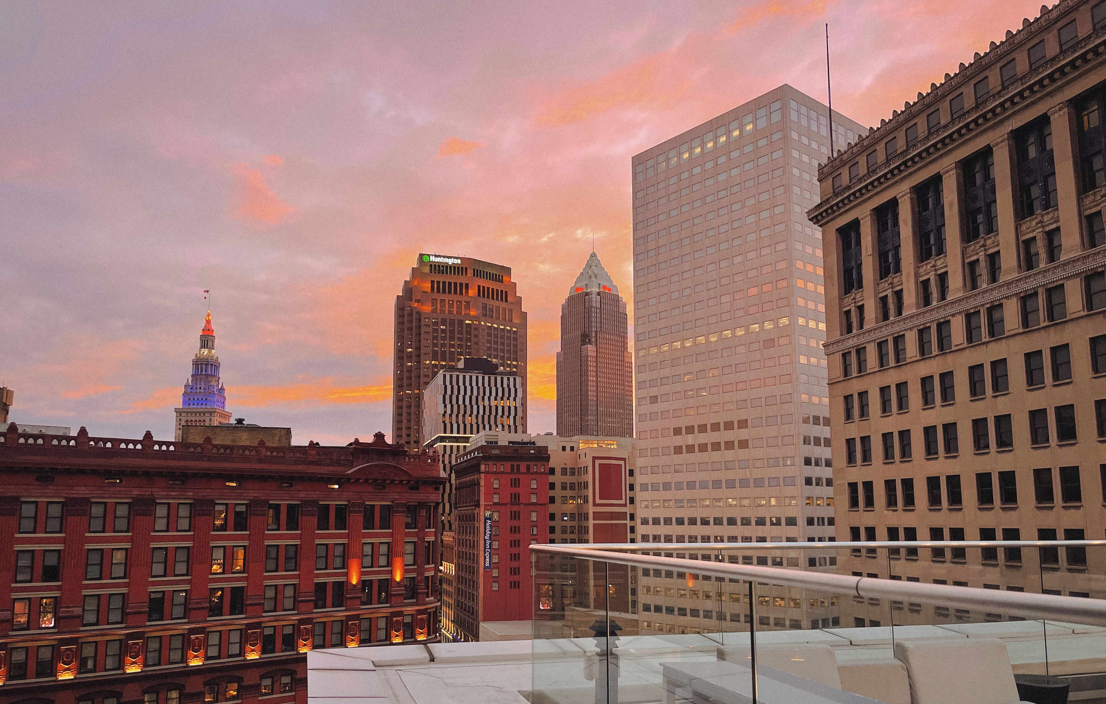 A cityscape with various buildings, including a hotel with a sign that appears to be 'Hampton Inn'.