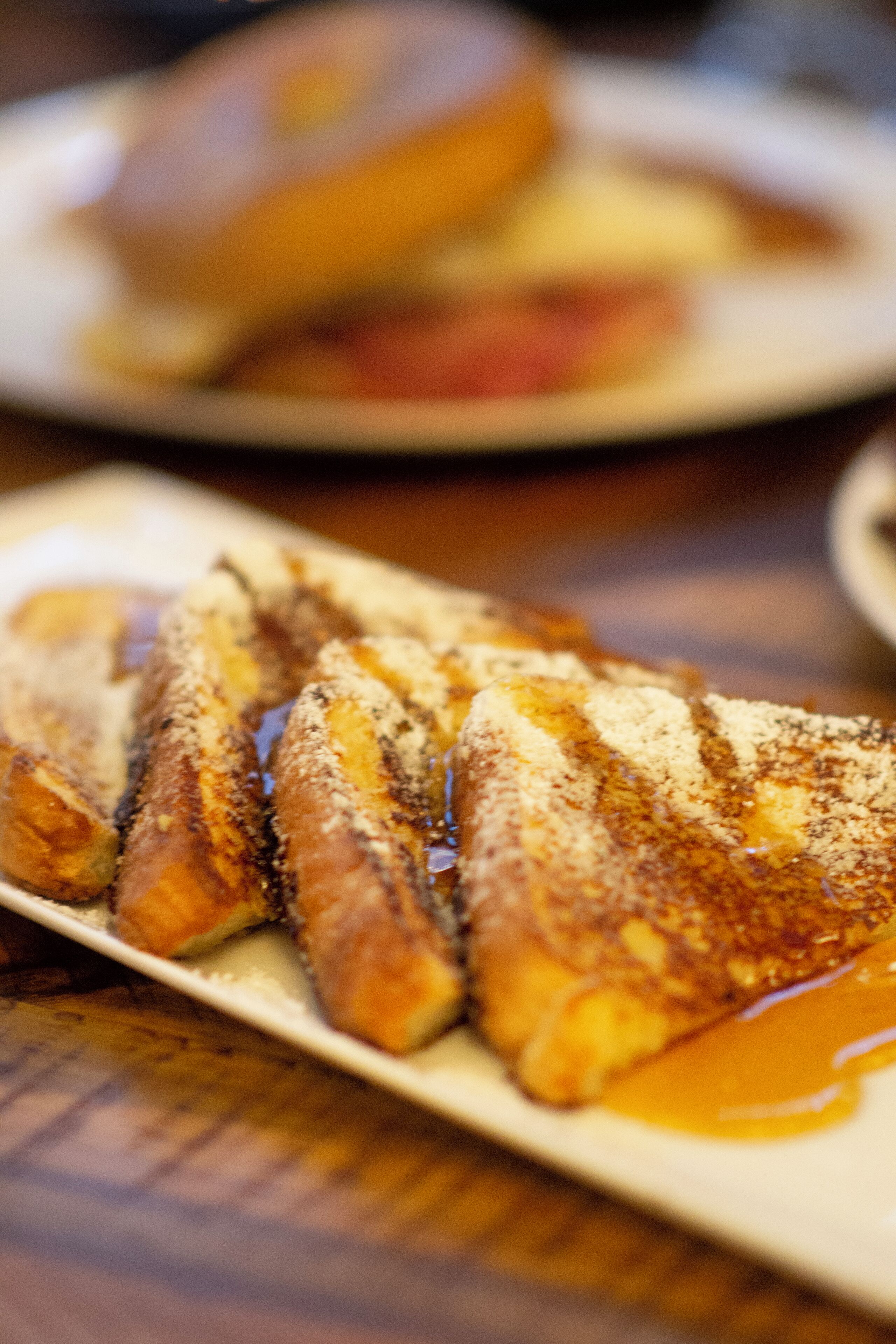 A plate of food with a sauce on a wooden table.