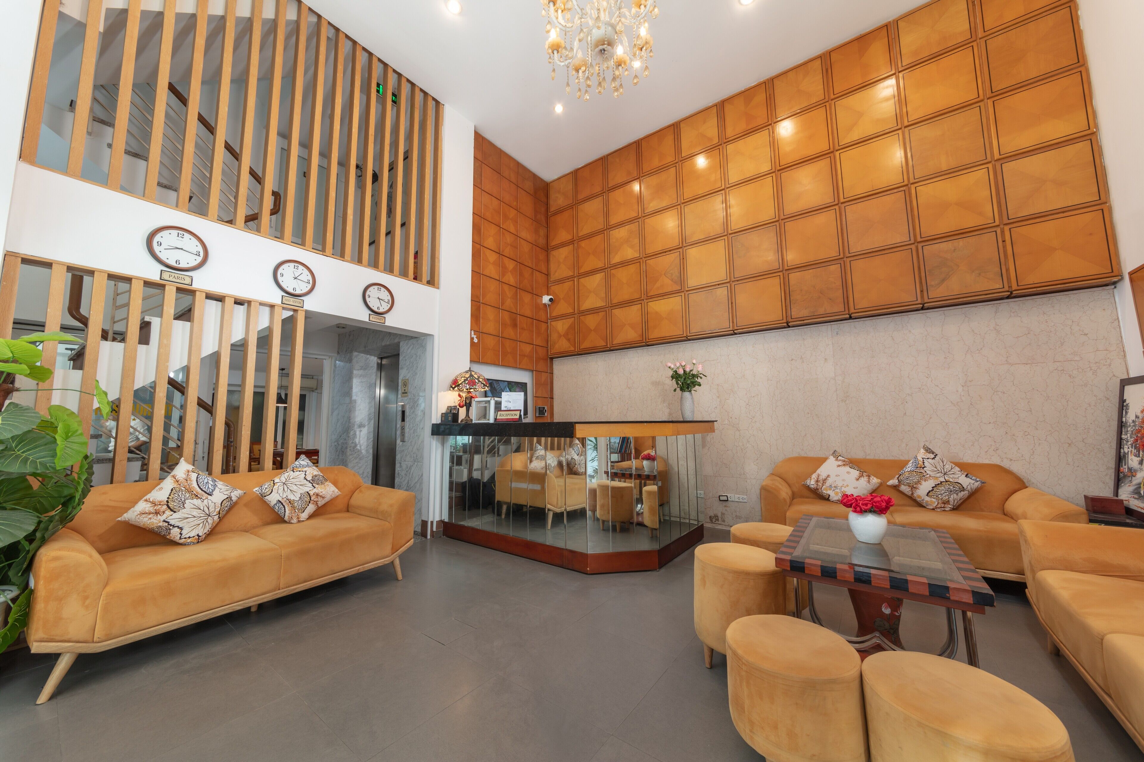 A modern living area with a sofa set, a coffee table, and a dining area with a glass partition.