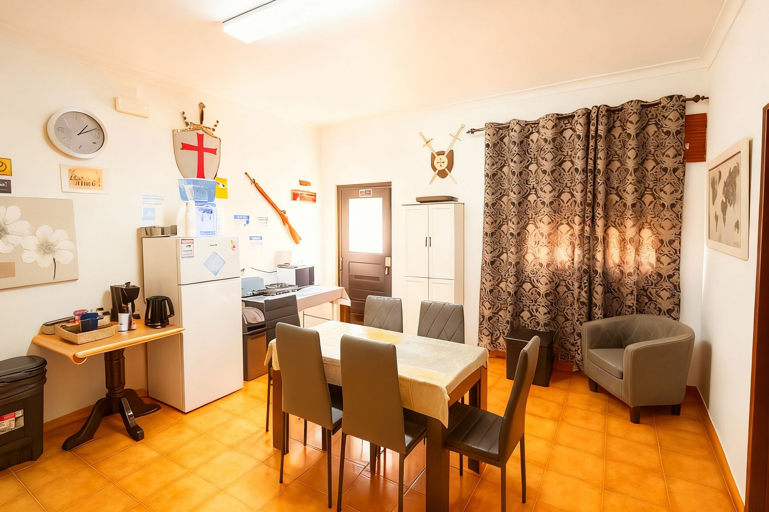A compact living space with a dining area, kitchen, and a small seating area.
