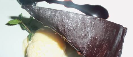 A dessert with a chocolate piece and a scoop of ice cream.