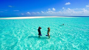 A clear turquoise sea with a sandy beach and a clear sky. - Thundi Sea View  (Fulidhoo)