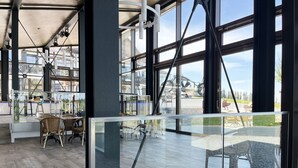 Une pièce spacieuse dotée de grandes fenêtres, d’une cloison en verre et offrant une vue sur l’extérieur.