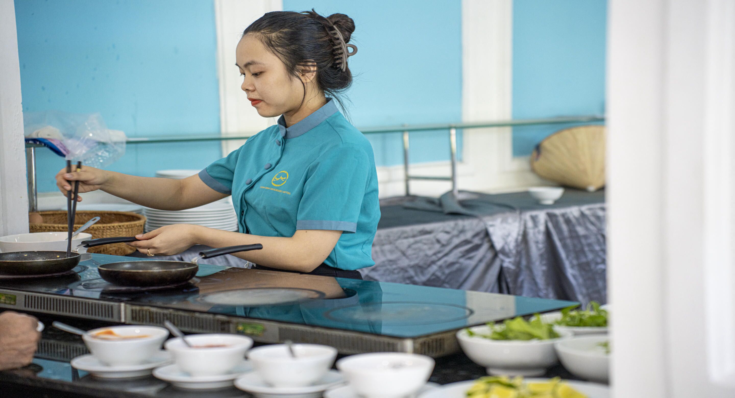 A person cooking at a table with various bowls and a basket.