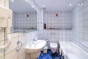 A modern bathroom with a sink, toilet, and bathtub. - Krini Beach Hotel (Rethymno)