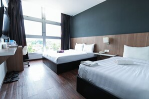 A hotel room with two beds, a desk, a chair, a TV, and a window with curtains. - Hotel 99 - Bandar Botanik Klang (Klang)