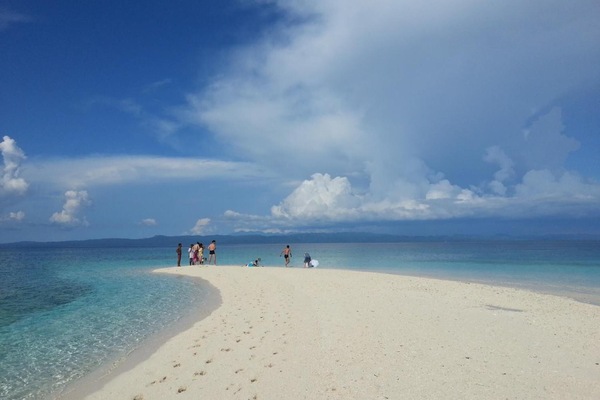 On the beach, white sand, sun loungers, beach umbrellas