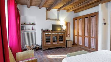 A cozy room with a wooden cabinet, a television, and a radiator.