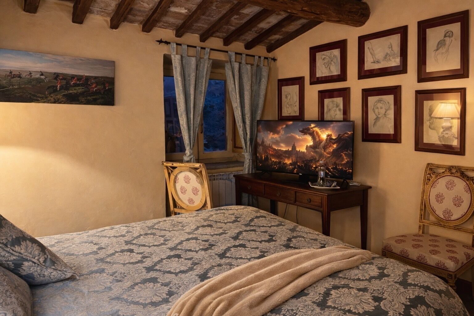 A bedroom with a bed, a television, framed artwork, and a window with curtains.