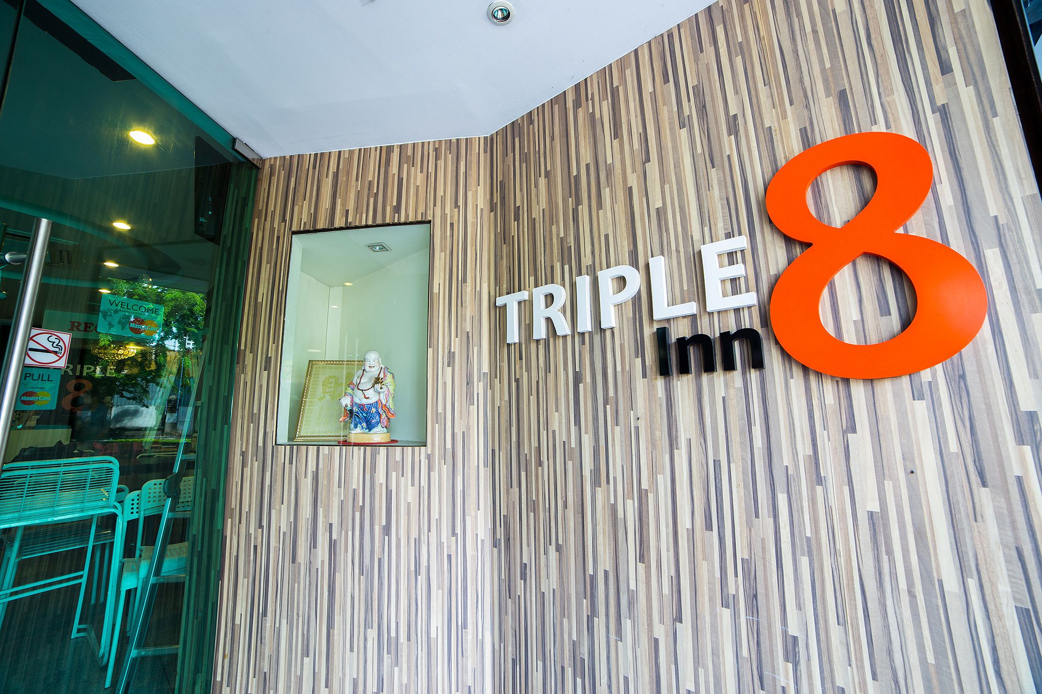 The exterior of Triple 8 Inn with a wooden panel design and a large '8' sign.