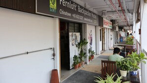 A hostel with a signboard for Fernloft Backpacker Hostel in Chinatown, including contact details and a website. - Fernloft Chinatown - Hostel (Singapore)