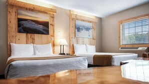 A hotel room with two beds, wooden paneling, a large window, and two paintings on the walls. - Caberfae Peaks Ski & Golf Resort (Cadillac)