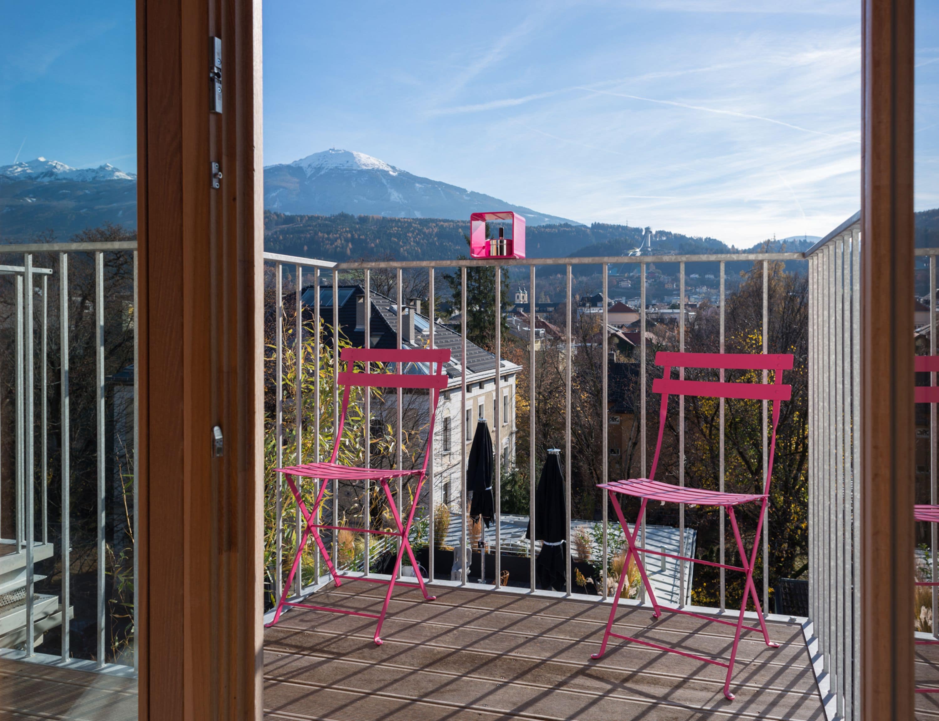 A balcony with a view of a mountain and a town.