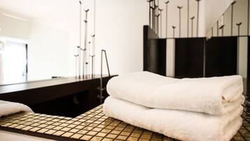 Ein Badezimmer mit Handtuchhalter, Waschbecken und Spiegel.