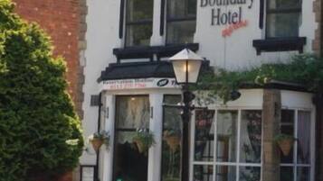 The Boundary Hotel with a traditional architectural style, featuring a prominent sign and a well-maintained facade.