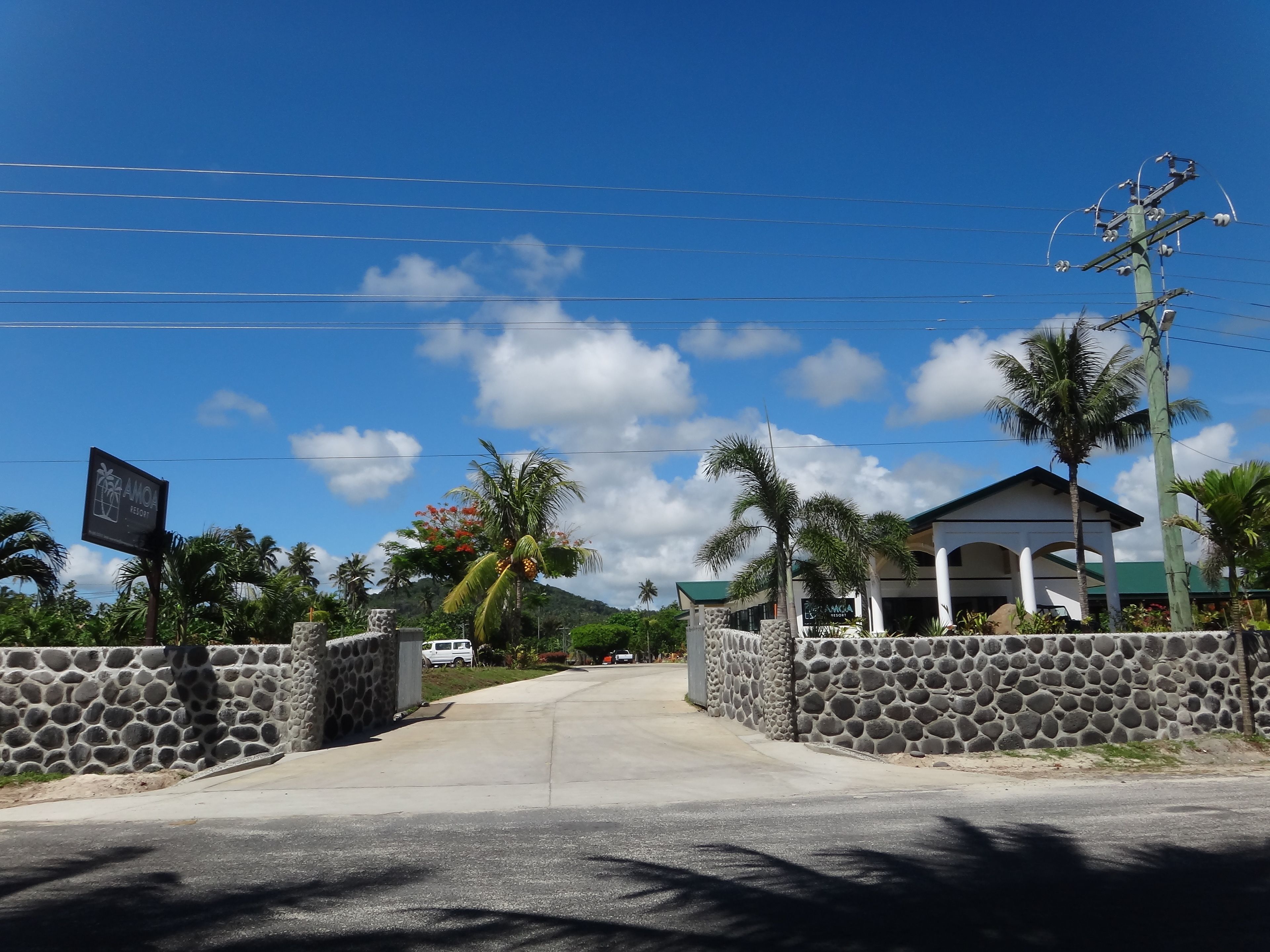 A stone-walled entrance to a building with a sign for "ANOA RESORT".