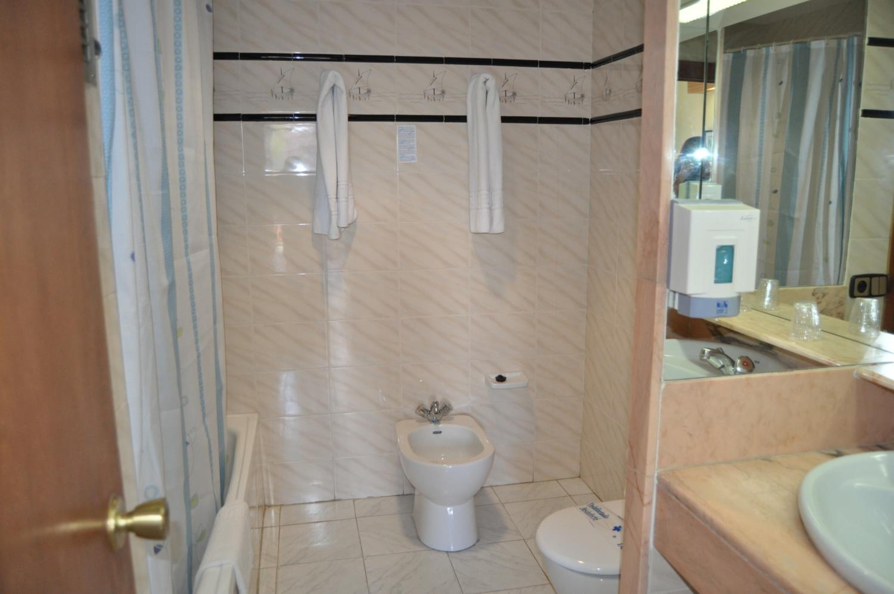 bathtub, free toiletries, hair dryer, towels