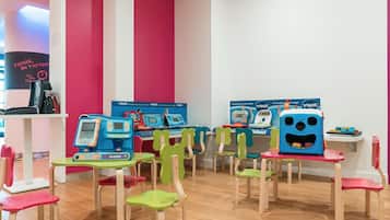 A children's learning area with educational stations and colorful chairs.