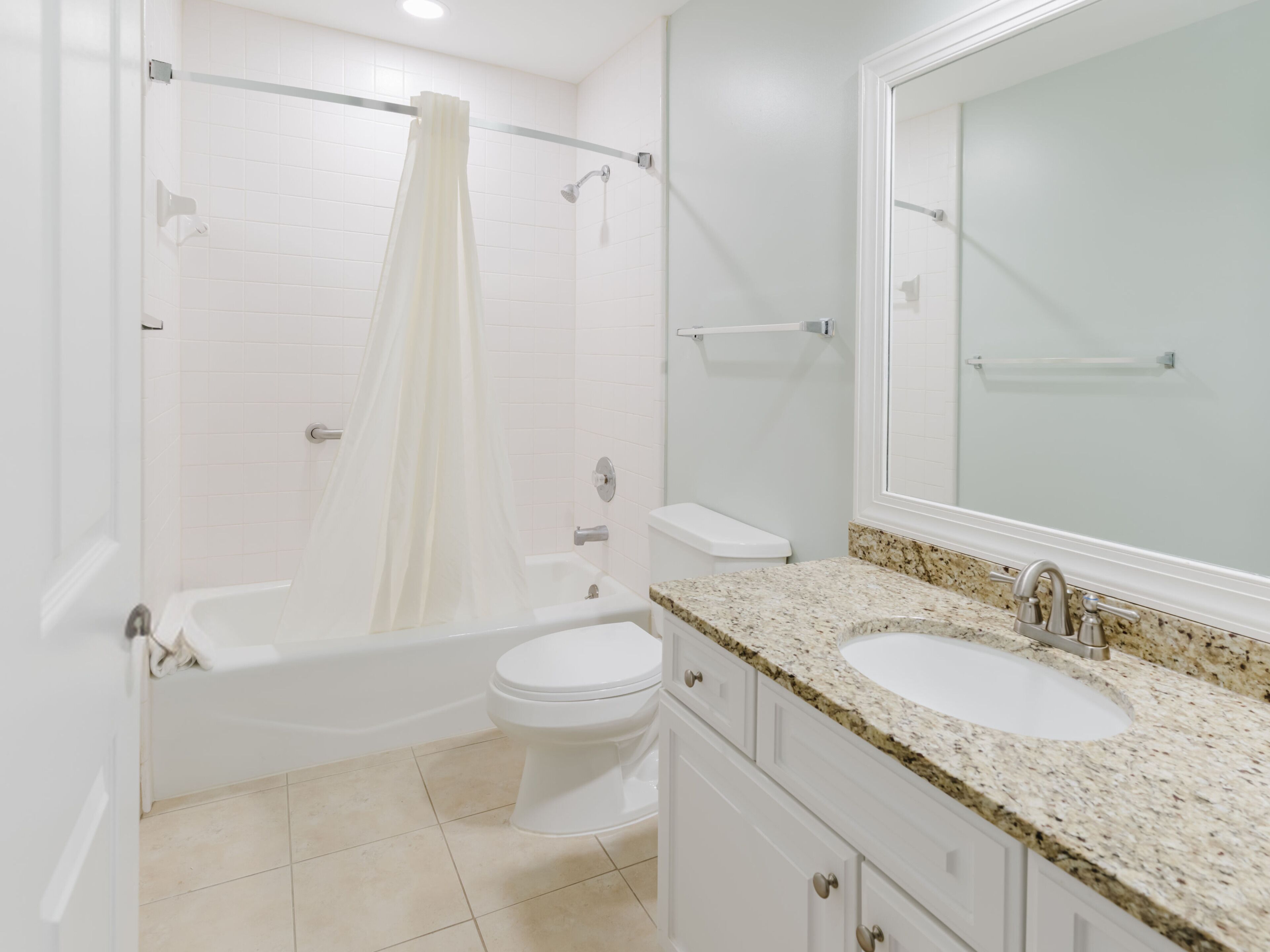 A bathroom with a bathtub, toilet, and sink.