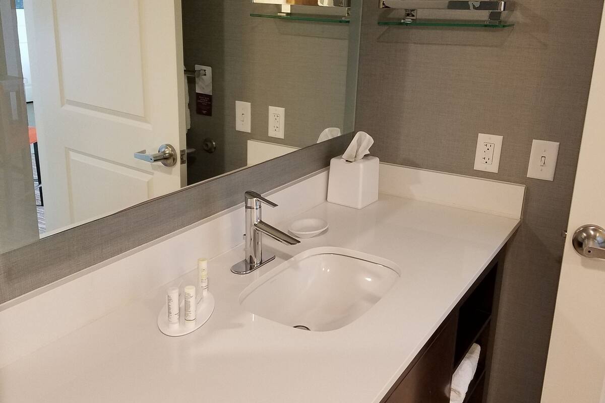 designer toiletries, hair dryer, towels, soap