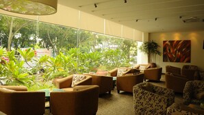 A modern lounge area with comfortable seating, large windows, and indoor plants. - The Jerai Hotel Alor Star (Alor Setar)