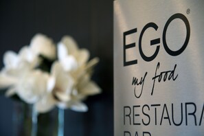 A metallic sign with the text "EGO my food RESTAURANT."
