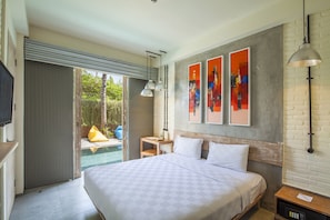 A modern hotel room with a large bed, a small table, a TV, and a view of a swimming pool.