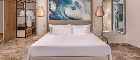 A modern bedroom with a large bed, a wardrobe, a mirror, and a painting of a wave.