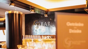 A bar area with a sign reading "G BAR" and a selection of bottles and glasses on the counter. - Hotel & Restaurant Goldener Pflug (Ludwigsburg)