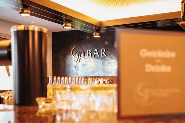 A bar area with a sign reading "G BAR" and a selection of bottles and glasses on the counter. - Hotel & Restaurant Goldener Pflug (Ludwigsburg)