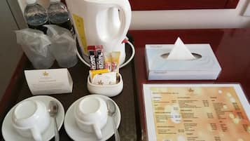 A tray with a coffee pot, cups, and a menu.
