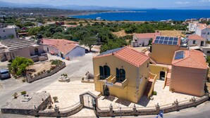 A coastal village with traditional architecture, including a building with a sign 'Standella'. - Skandalis Traditional Suites (Chania)