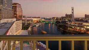 A cityscape at dusk with a river, illuminated buildings, and a bridge. - Aloft by Marriott Tampa Downtown (Tampa)