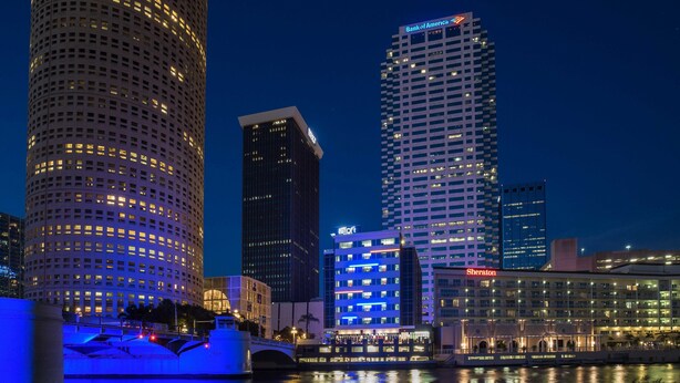 A cityscape with illuminated skyscrapers, a bridge, and a waterfront. - Aloft by Marriott Tampa Downtown (Tampa)