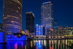 A cityscape with illuminated skyscrapers, a bridge, and a waterfront. - Aloft by Marriott Tampa Downtown (Tampa)