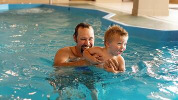 An indoor swimming pool with clear blue water.