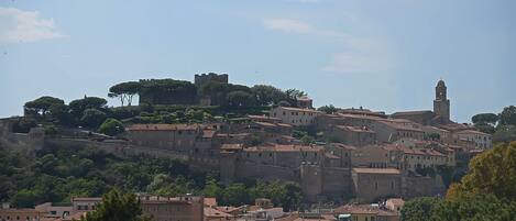 A historic town with medieval architecture, including a prominent tower and fortified walls.