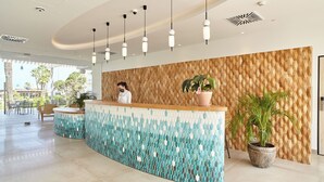 A reception area with a wooden wall, a tiled floor, and hanging pendant lights. - Can Salia (Sant Josep de sa Talaia)
