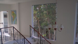 A staircase with a curved railing, leading to an upper level. - Ruta del Sol (San Bernardino)
