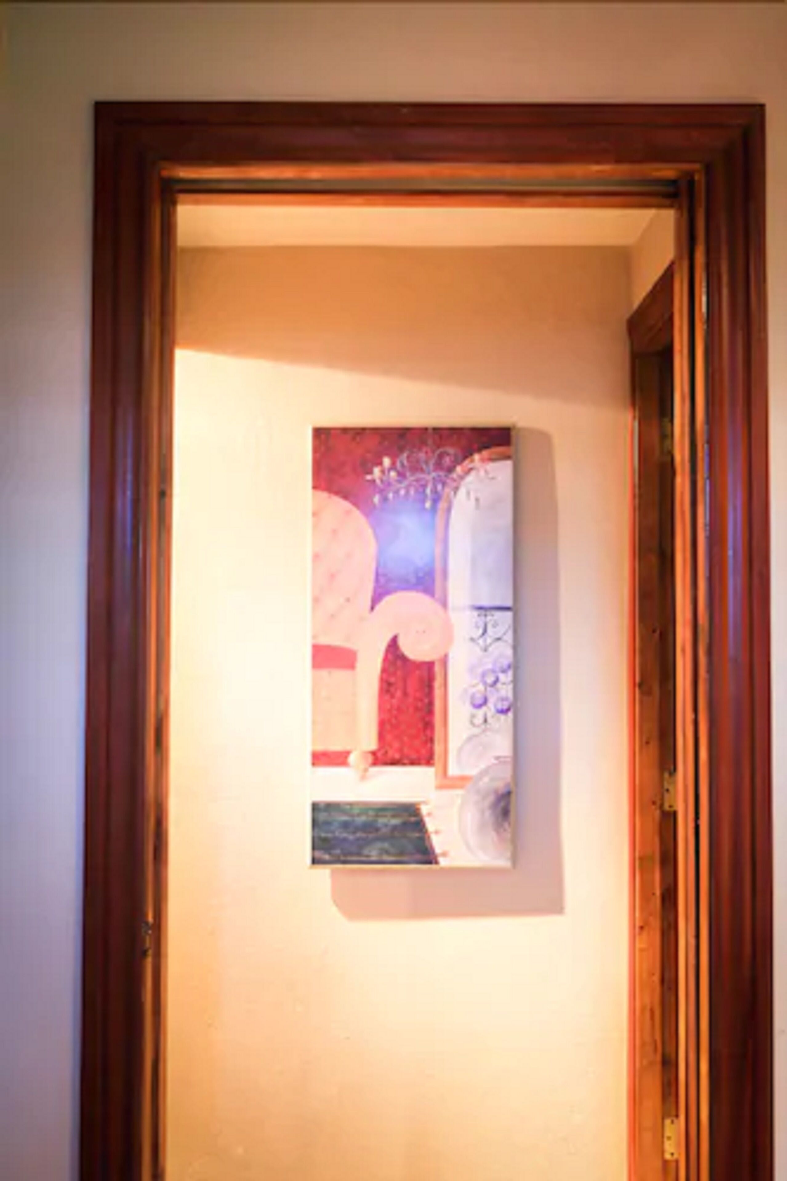A framed abstract painting on a wall.