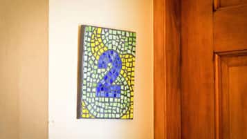 A mosaic artwork with a prominent number '2' on a wall.
