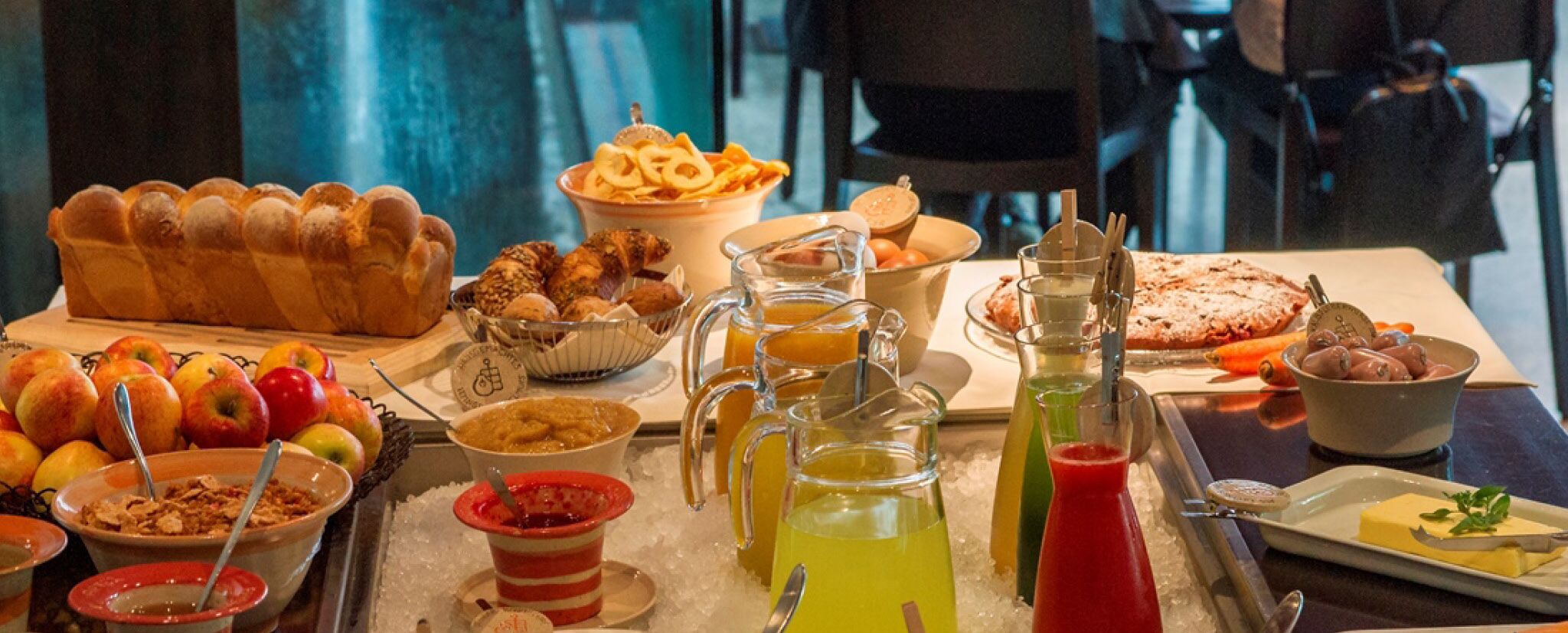 A buffet table with various food items and beverages.